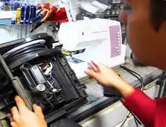 Vacuum repair technician servicing internal components on a workbench in Pittsburgh, PA