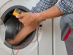 Washing machine repair technician testing a front-load washer with diagnostic tools in Pittsburgh, PA